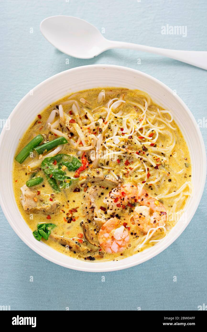 Grilled chicken king prawn laksa soup Stock Photo Alamy