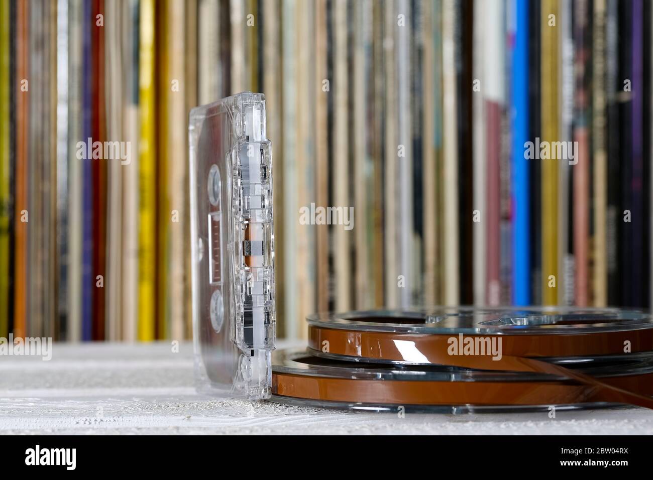Music tapes, compact cassette and vinyl records on a shelf visible from