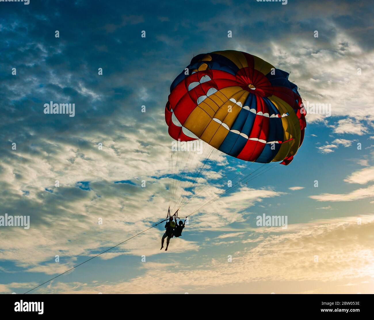 Parachuting ing thr Evening Clouds Stock Photo
