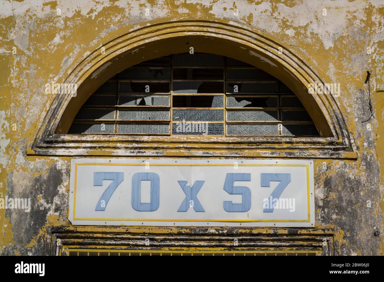 Old tattered advertisement for 70x50 beer, Merida, Yucatan, Mexico Stock Photo