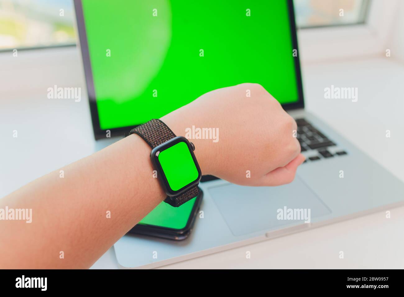 watch by use multiple internet electronic devices with green screen Stock Photo