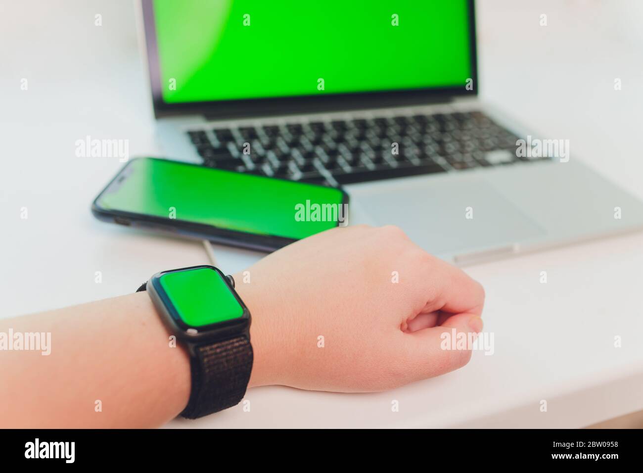 watch by use multiple internet electronic devices with green screen Stock Photo