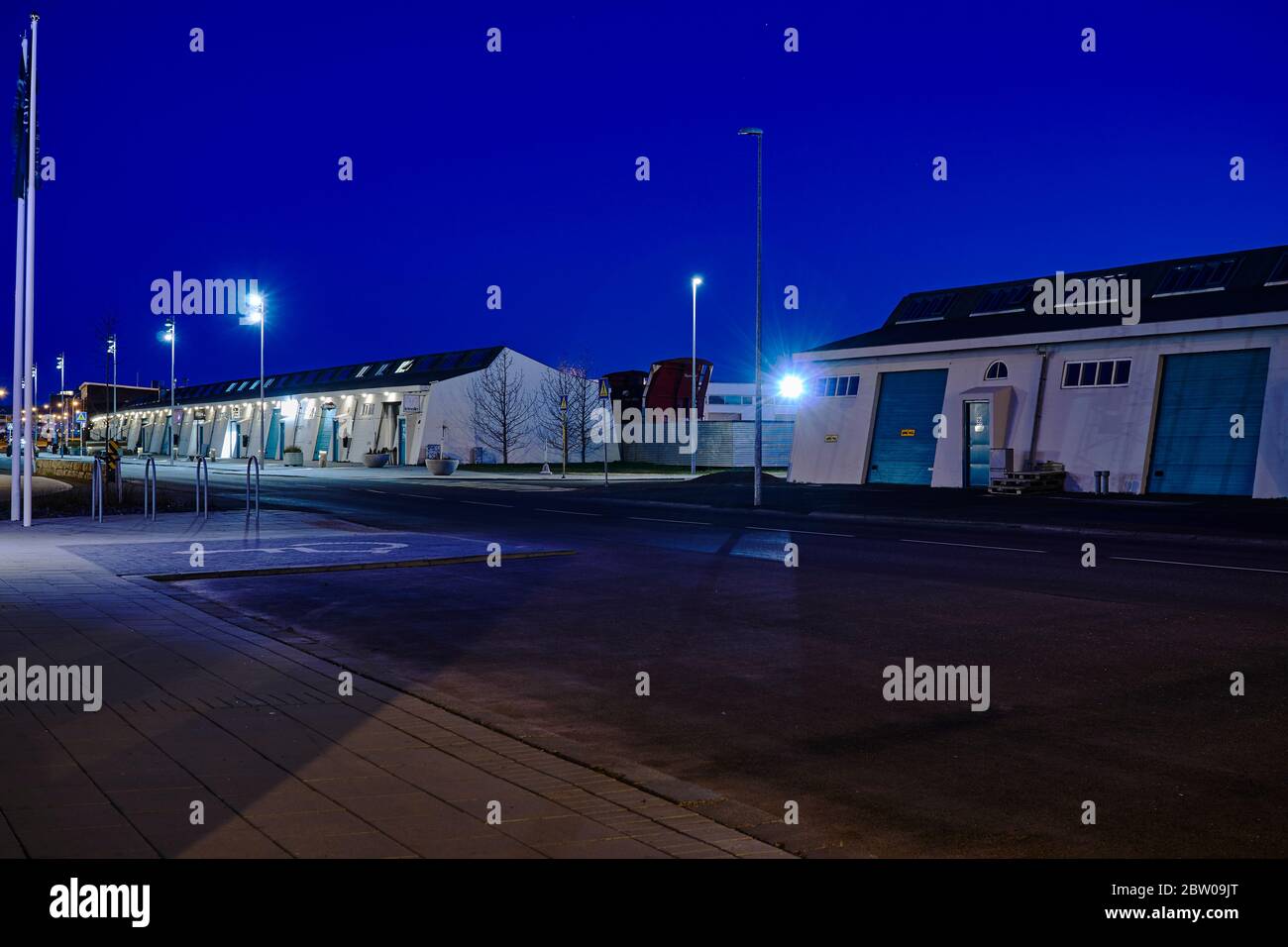 Buildings and equipment in the Reykjavik harbor area, shot in the deep blue light of summer midnight Stock Photo