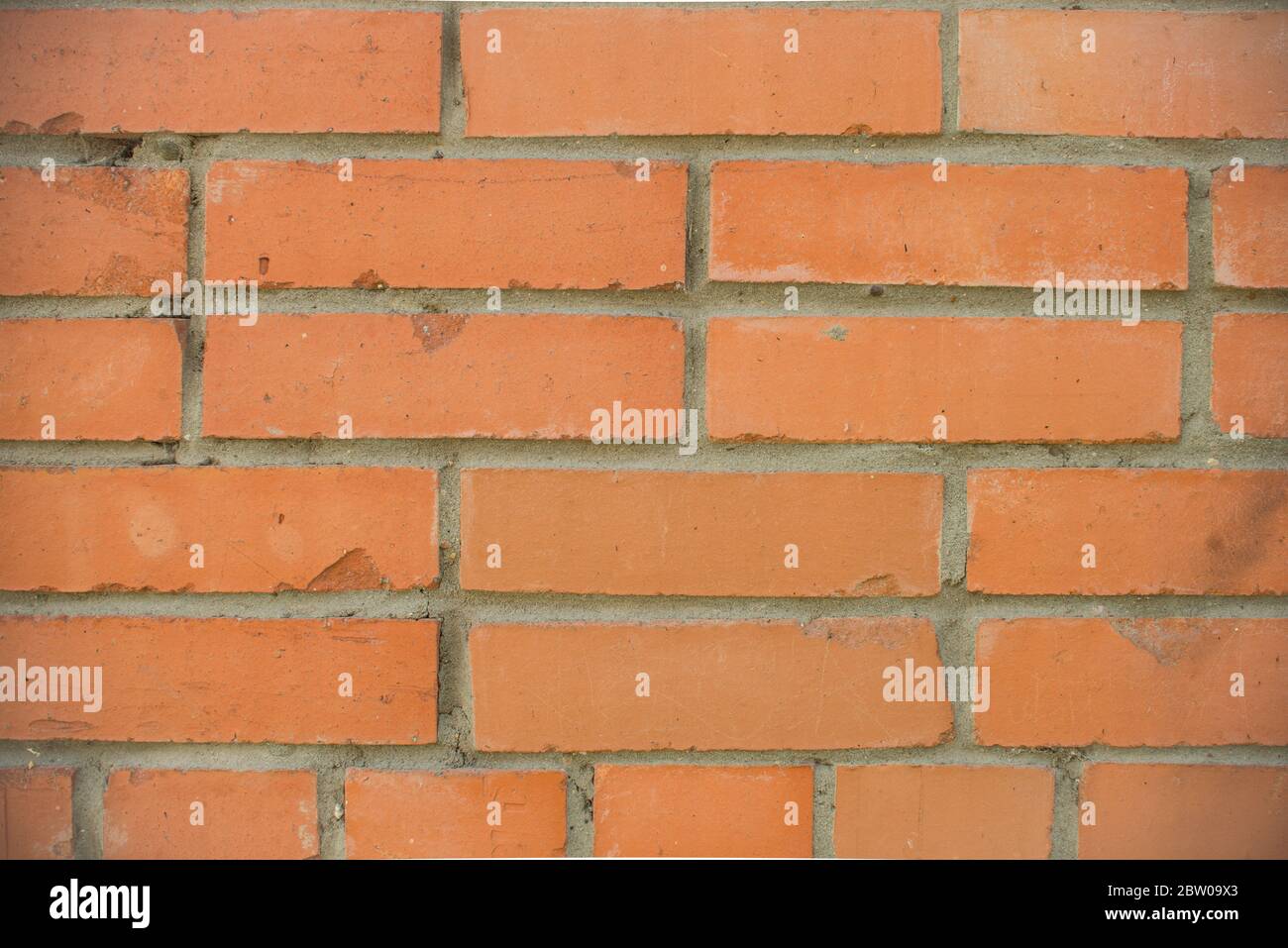 Orange bricks wall close up background. Stained old brick wall texture. Stock Photo