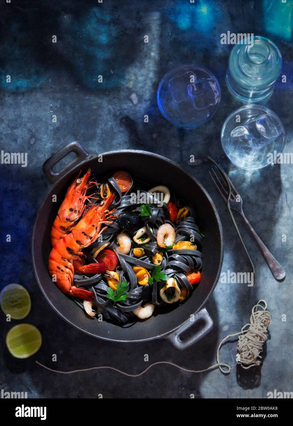 Seafood black ink linguine pasta with shrimps, king prawns Stock Photo