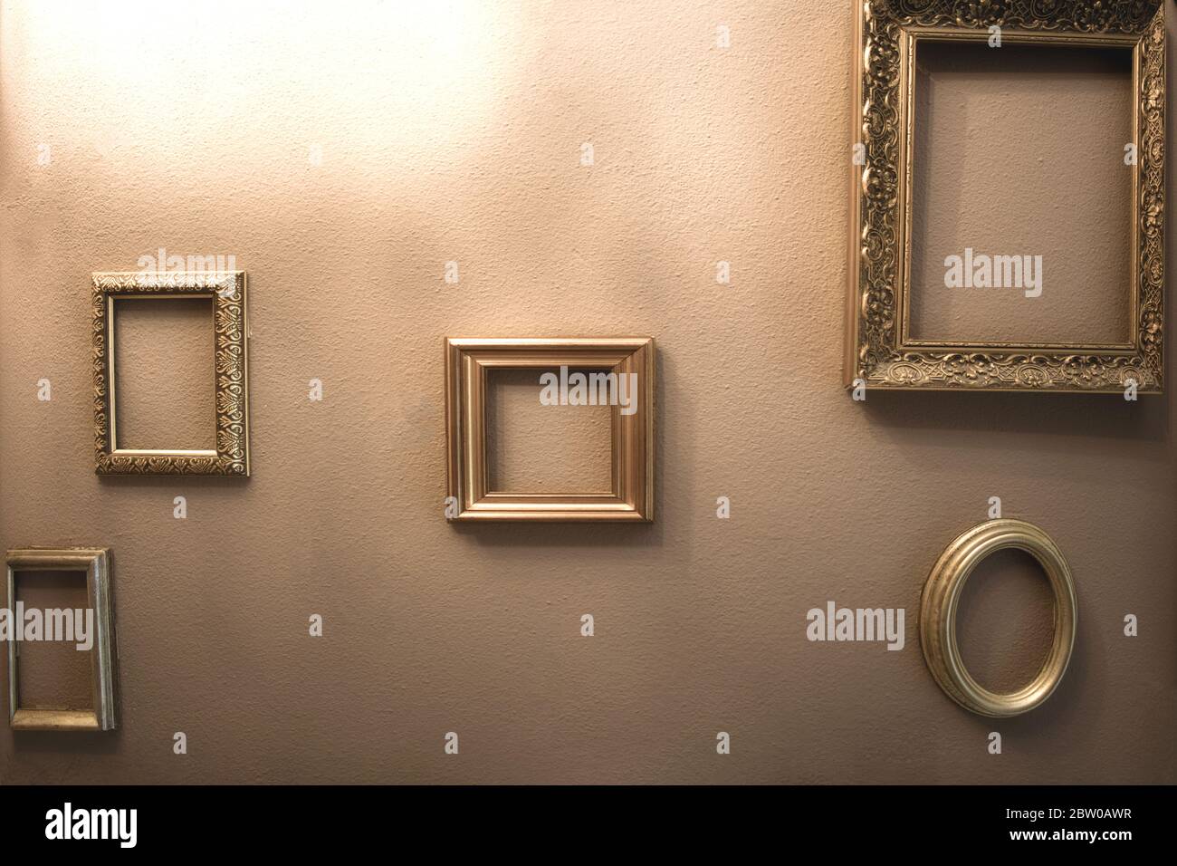 Empty golden luxury frames on vintage design wall, space for text