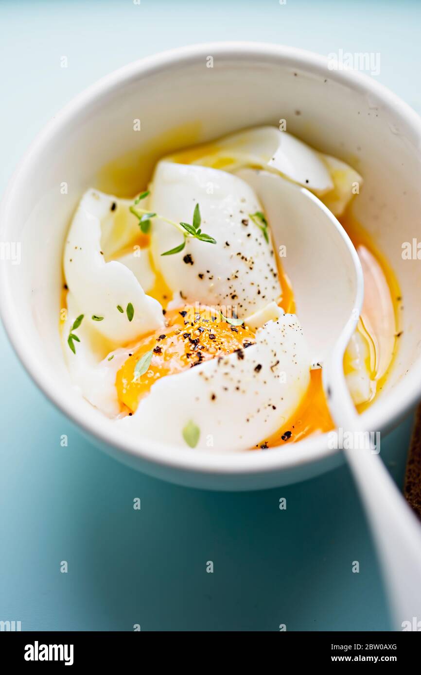 Soft boiled eggs with pepper and thyme Stock Photo