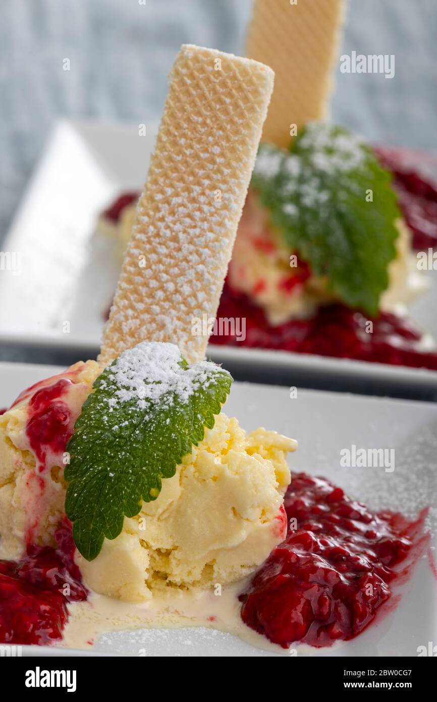 vanilla ice cream with hot raspberry sauce Stock Photo Alamy