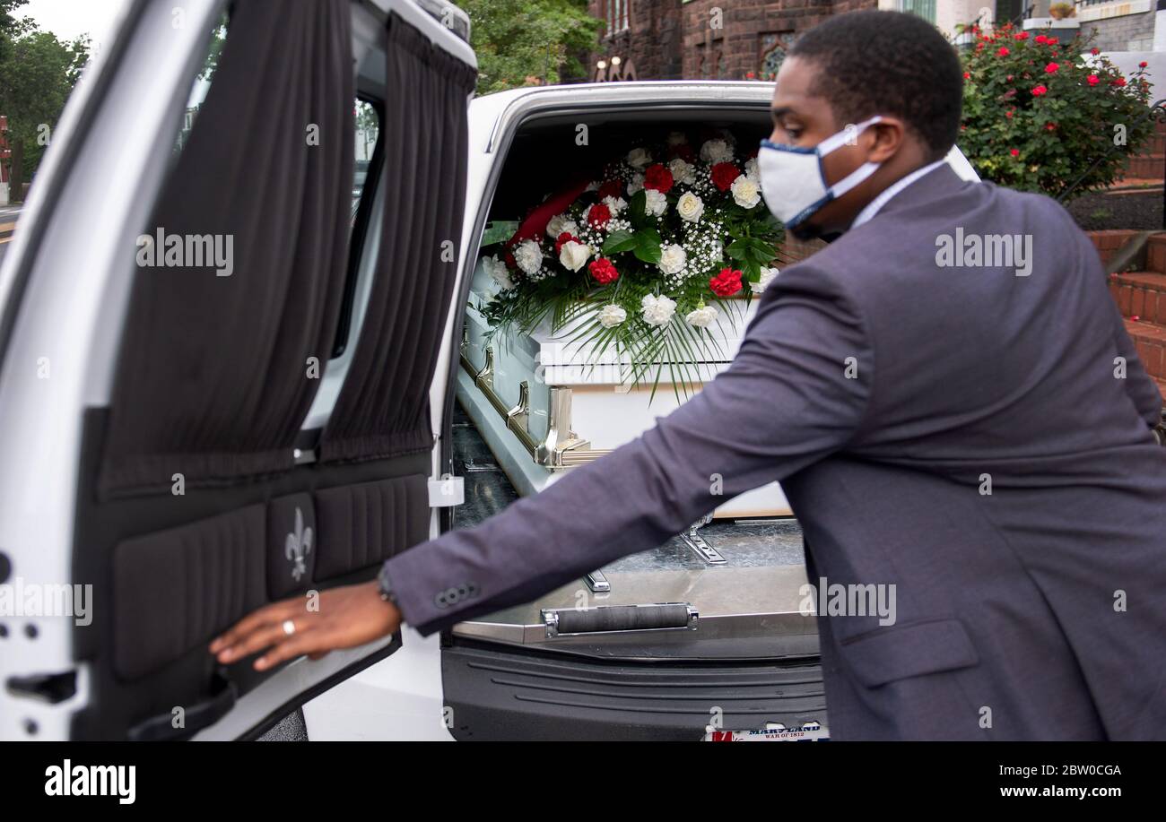 Washington, United States. 28th May, 2020. A man closes the door on the hearse containing the casket of Evelyn Moore Smith, who passed away at 68 years of age from COVID-19, out of Ronald Taylor II Funeral Home, in Washington, DC on Thursday, May 28, 2020. Photo by Kevin Dietsch/UPI Credit: UPI/Alamy Live News Stock Photo