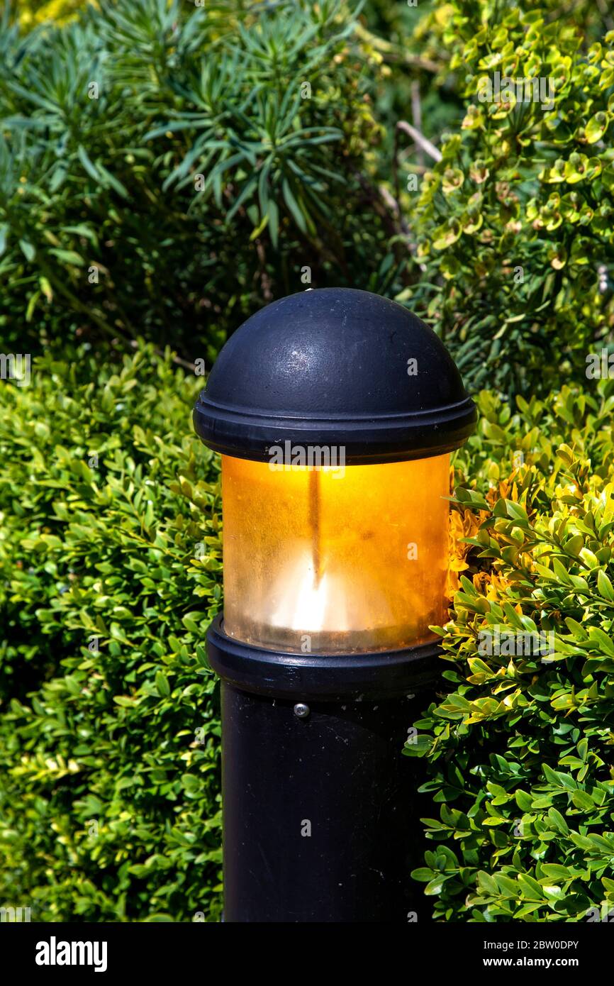 Street lantern light on during the day, wasting electricity, London, UK Stock Photo