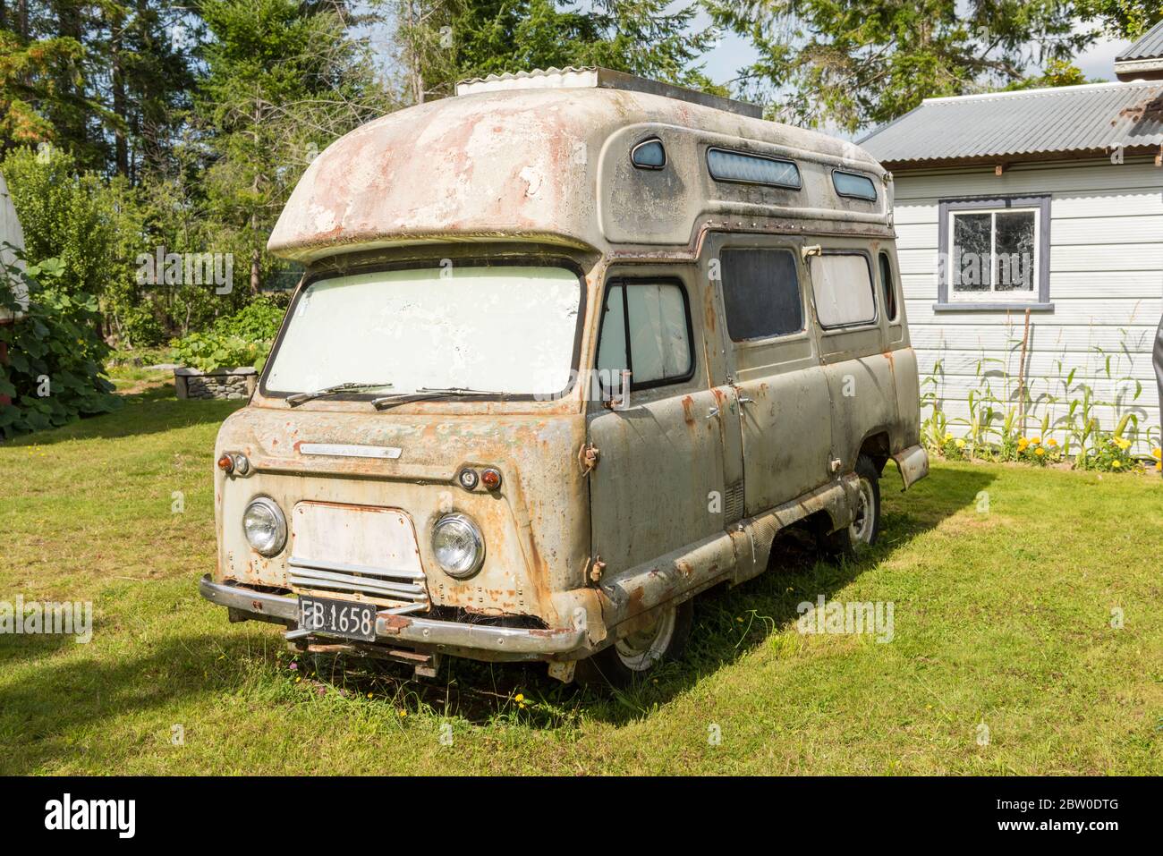An old vintage Leyland campervan rusting away on a campiste at