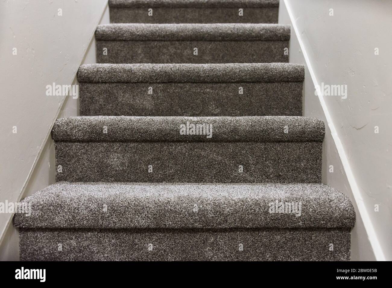 Freshly laid neutral grey carpet on stairs Stock Photo