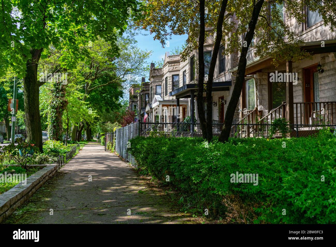 Sidewalk next to a Row of Old Homes in Logan Square Chicago Stock Photo