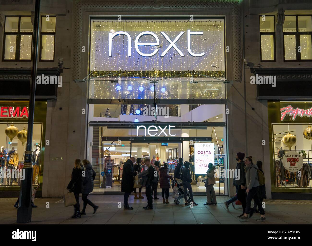 Retail store Next main entrance at night on Oxford Street. London Stock Photo