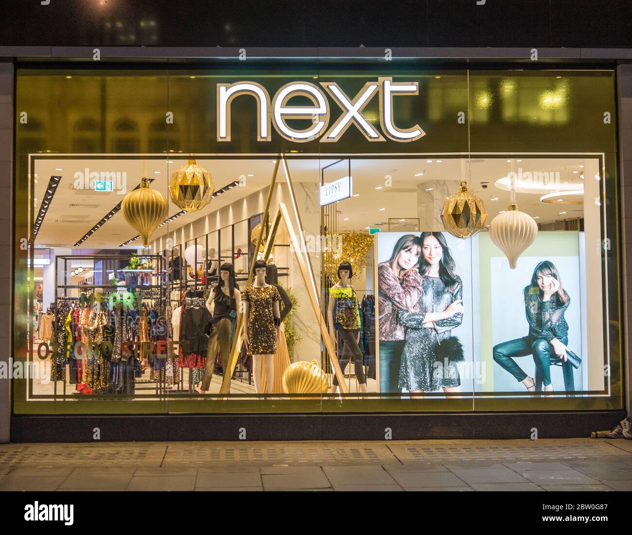 Retail store Next window display at night on Oxford Street. London Stock Photo