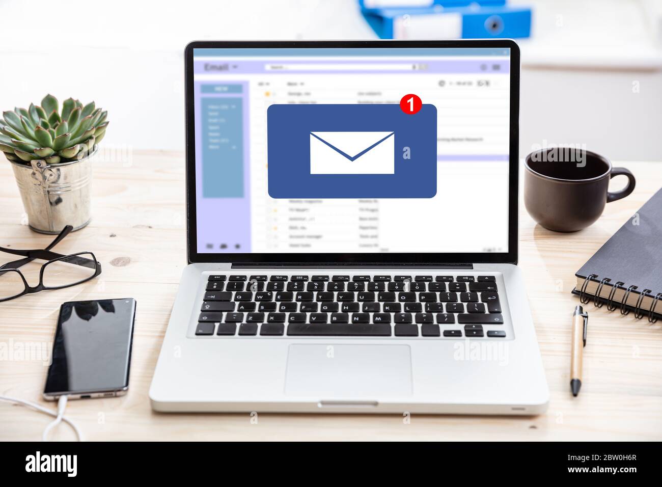 Email notification concept, one new inbox e mail, envelope with incoming message on computer laptop screen, business office desk background Stock Photo