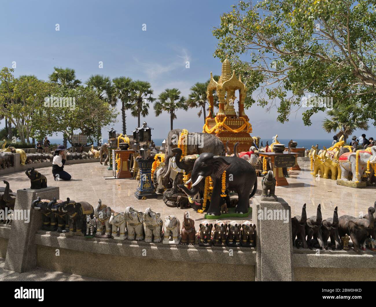 dh Promthep Cape Phra Prom Area PHUKET THAILAND Elephant statues Thai woman praying at Brahma hindu shrine hinduism local person people Stock Photo