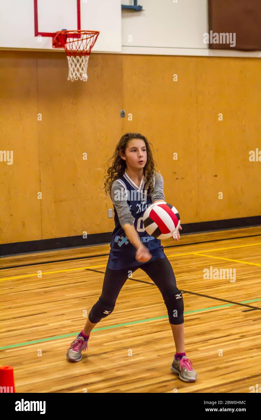 Girls volley-ball, 8 to 10 years old, serving. Stock Photo