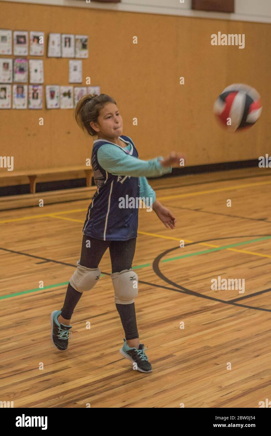 Girls volley-ball, 8 to 10 years old, serving. Stock Photo