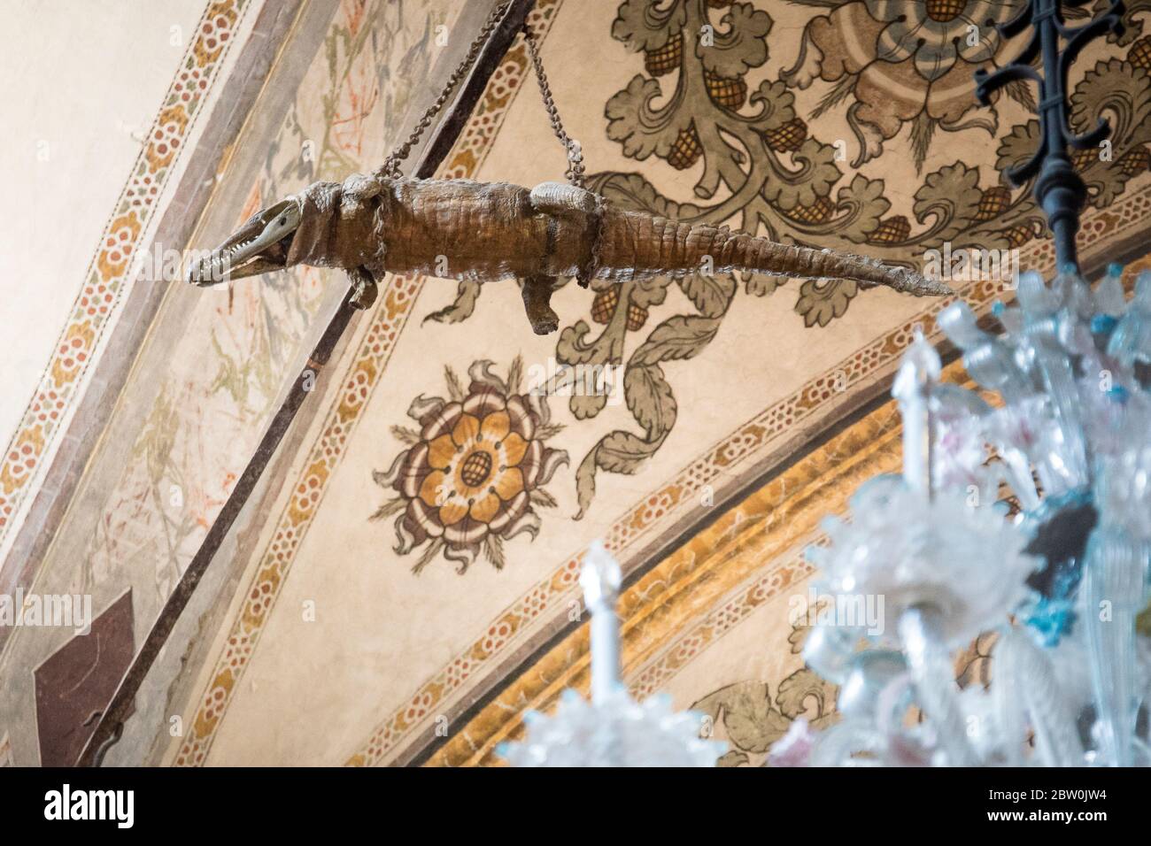 The crocodile hanging from the ceiling in the Sanctuary of Santa Maria delle Grazie, Curtatone, Province of Mantua, Italy. Chandelier in the foregroun Stock Photo