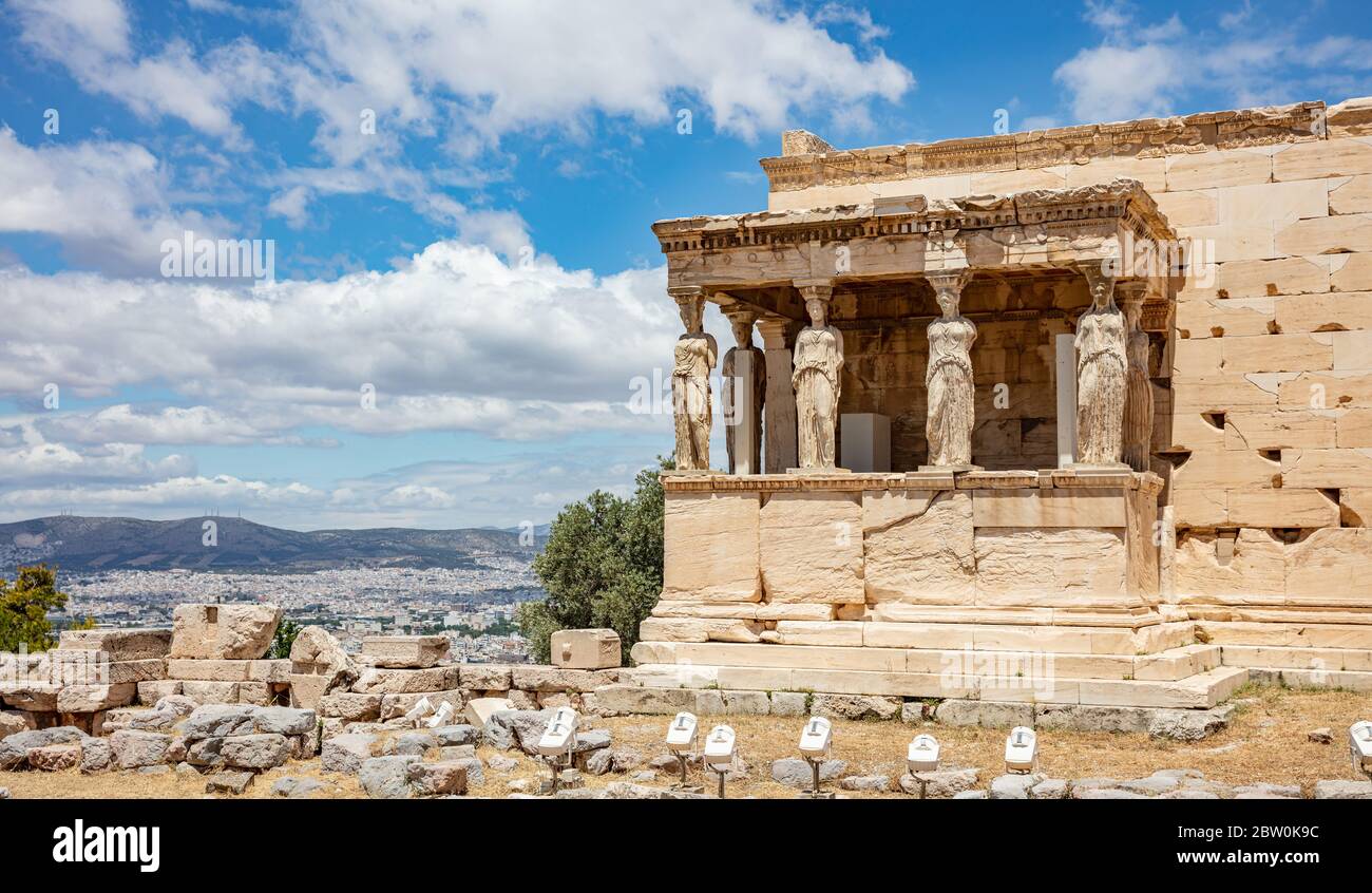 Athens Acropolis, Greece landmark. Erechtheion, Erechtheum, Temple of Athena with Caryatid Porch, Ancient Greek ruins, blue sky in spring sunny day. Stock Photo