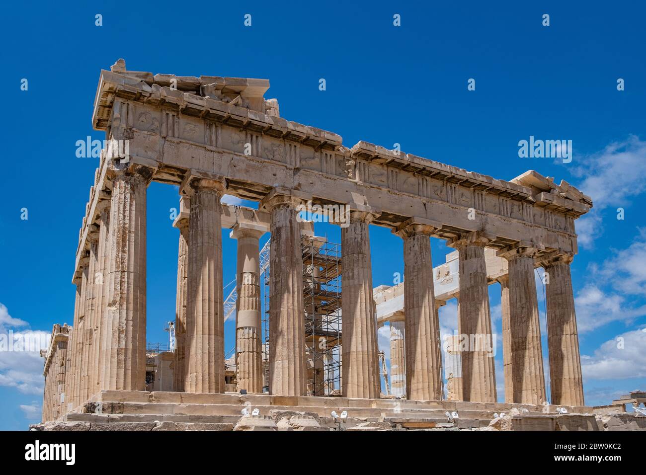 Athens Acropolis, Greece. Parthenon temple facade, ancient temple ruins, equipment for restoration works, blue sky, low angle view Stock Photo