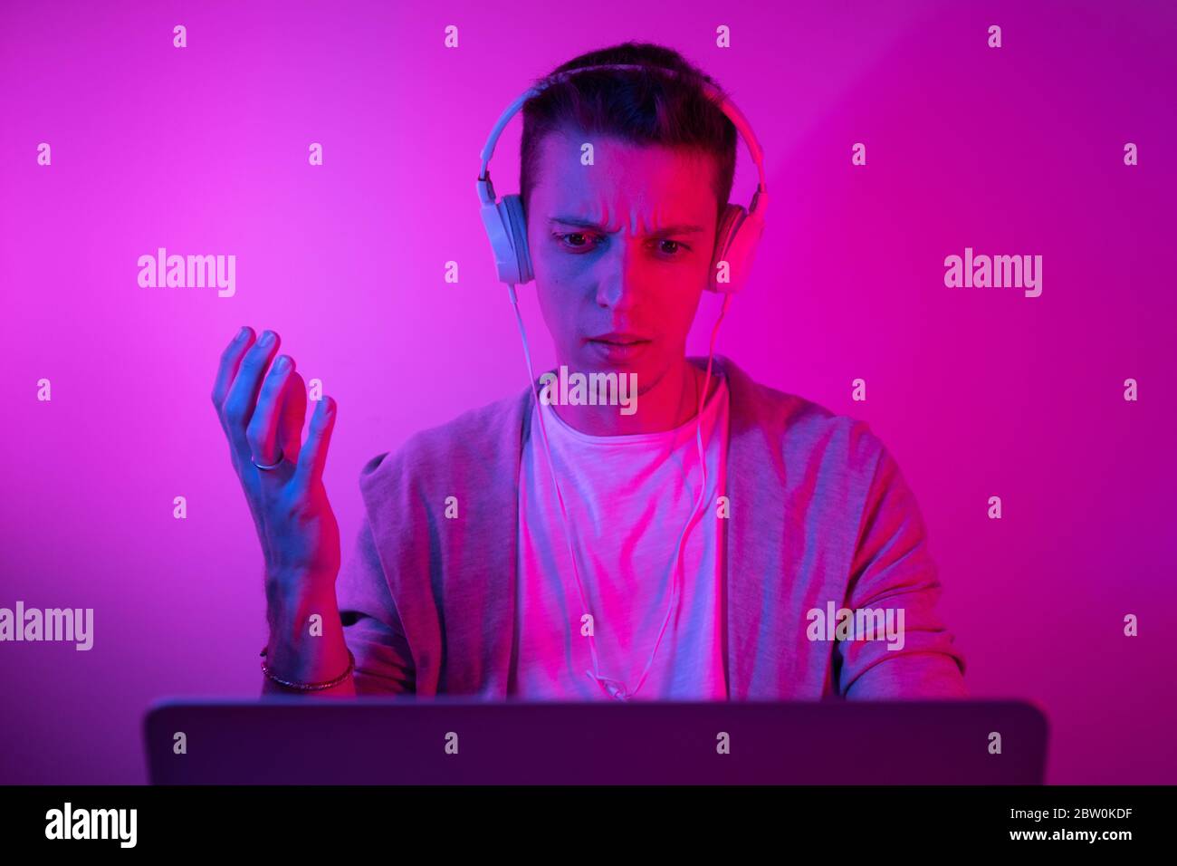 Gamer plays on a laptop. The programmer writes the code. Man on a ...