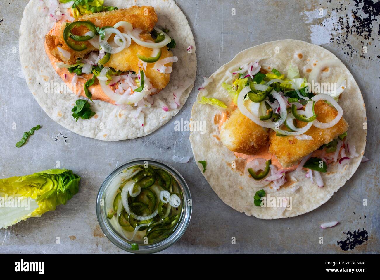 Fish tacos with cod, harrisa sauce, pickled onions and chili Stock Photo