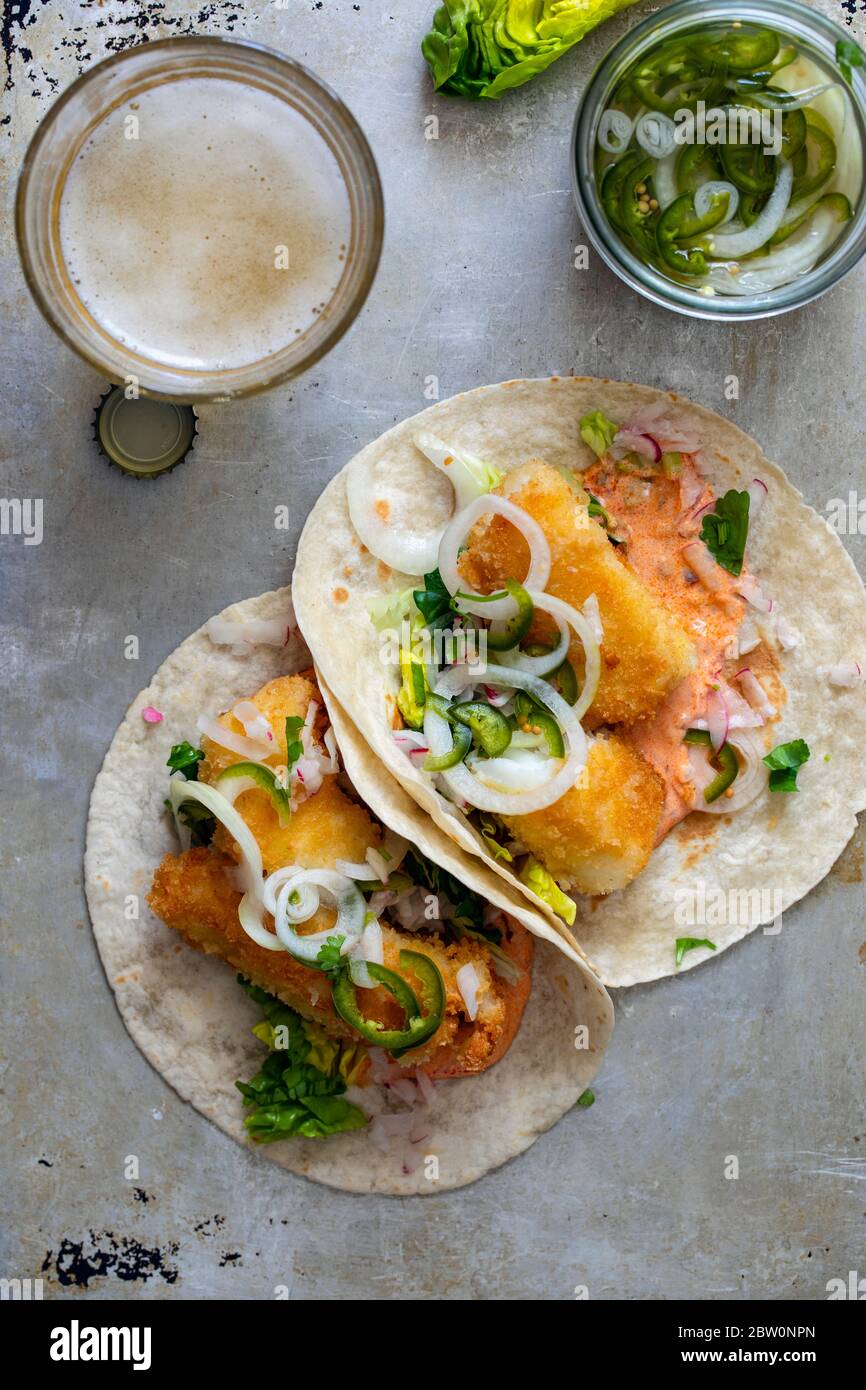Fish tacos with cod, harrisa sauce, pickled onions and chili Stock Photo
