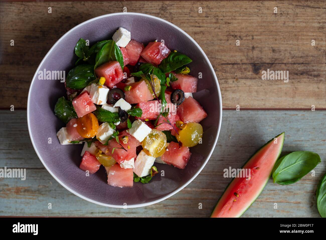 Summer salad with watermelon, tomatoes, feta cheese and basil Stock Photo