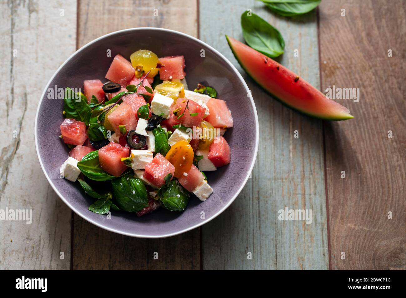 Summer salad with watermelon, tomatoes, feta cheese and basil Stock Photo