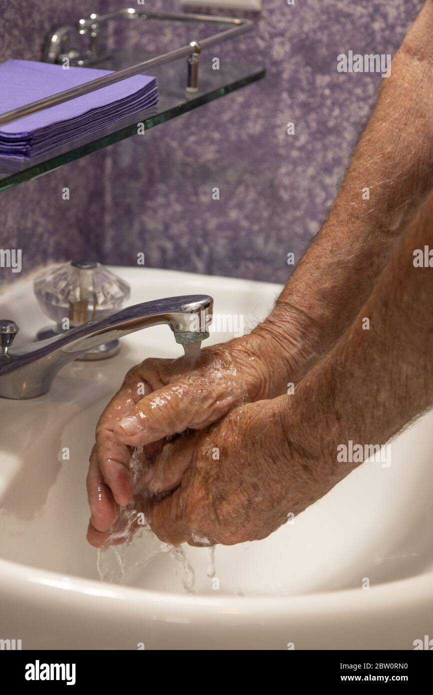 Hands under running water faucet water dripping Stock Photo