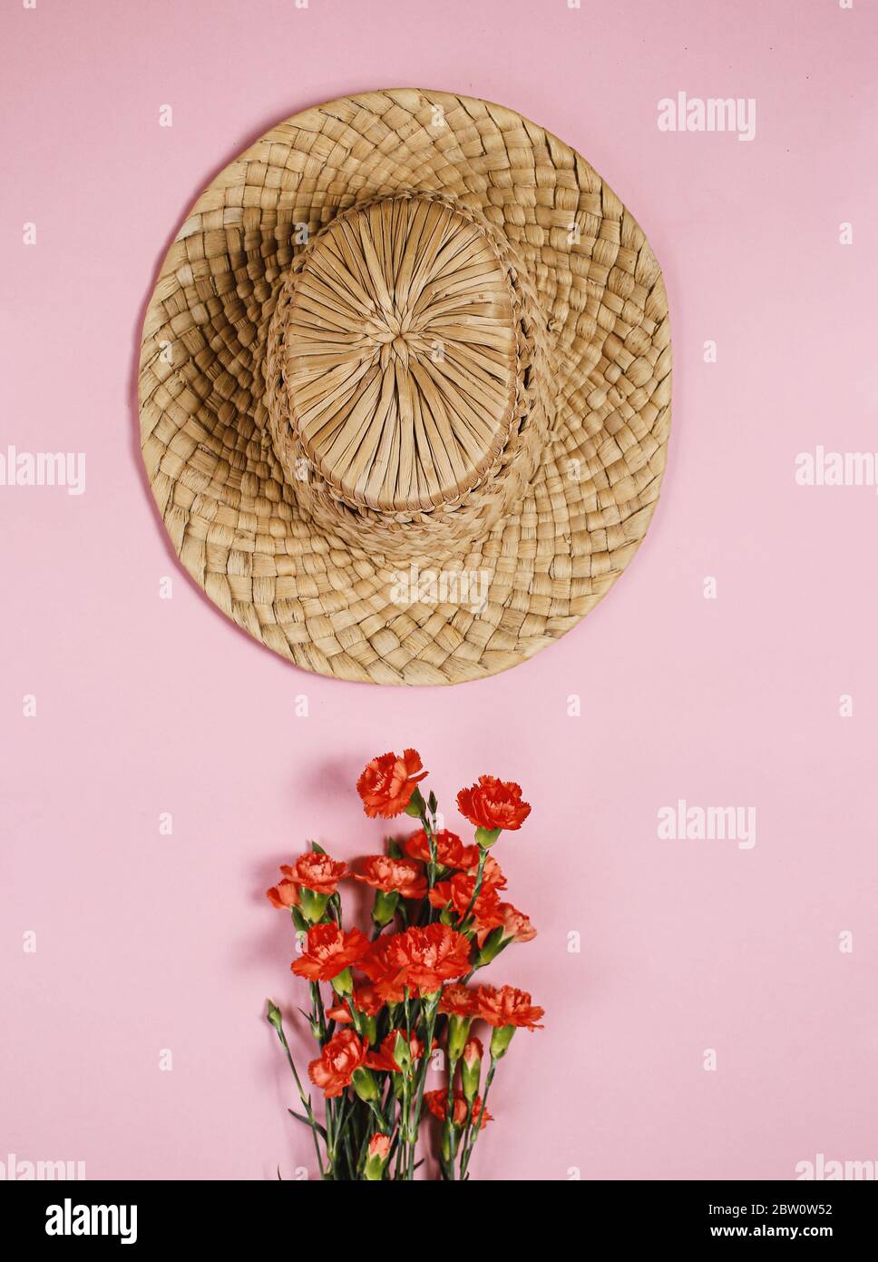 vintage hat on pink background with flower bouquet Stock Photo - Alamy