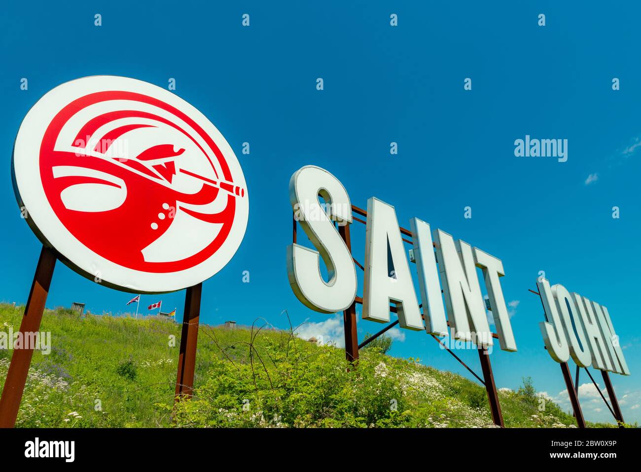 Saint John, NB, Canada - July 20, 2019: The 'Saint John' sign overlooks the harbor from Fort Howe. The cities 'Loyalist' logo is to the left of the si Stock Photo