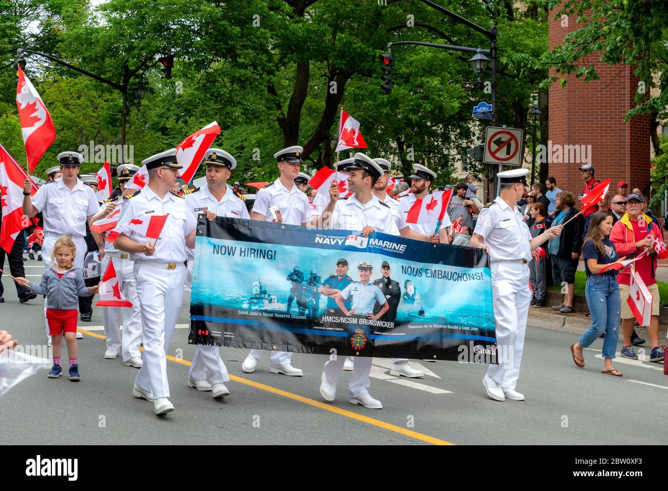 Saint John, New Brunswick, Canada - July 1, 2019: Naval officers participate in the Canada Day parade. The carry a recruiting banner. Stock Photo
