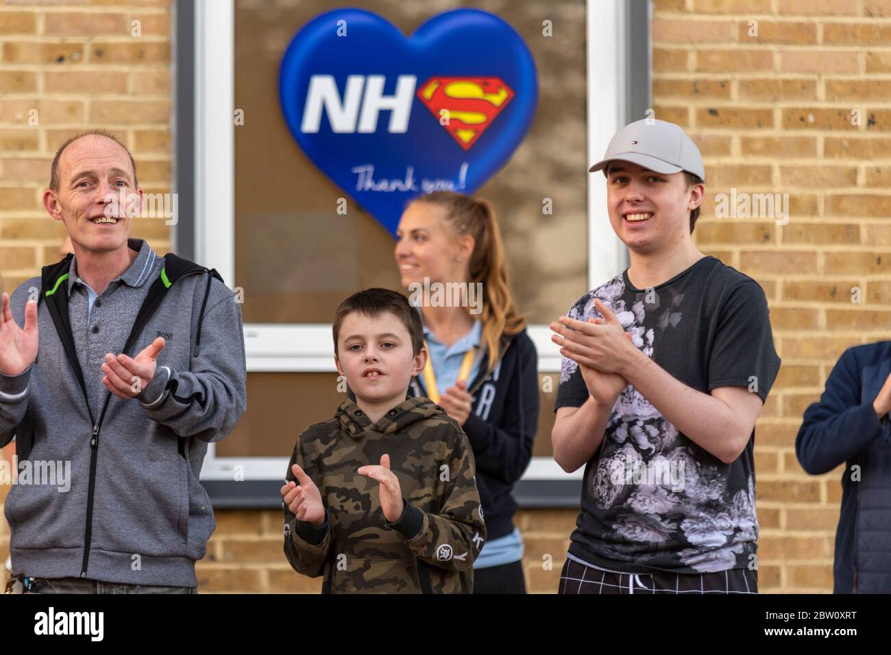Final clap for carers at 8pm Thursday outside Southend University Hospital, Essex, UK. Members of the public clapping below NHS Superhero thank you Stock Photo