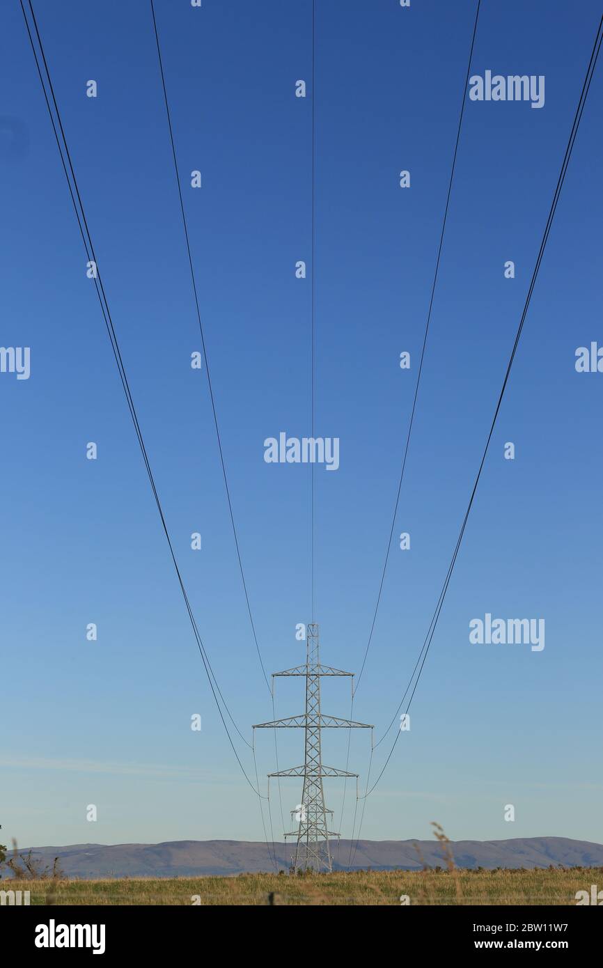 High voltage power lines against blue sky Stock Photo - Alamy