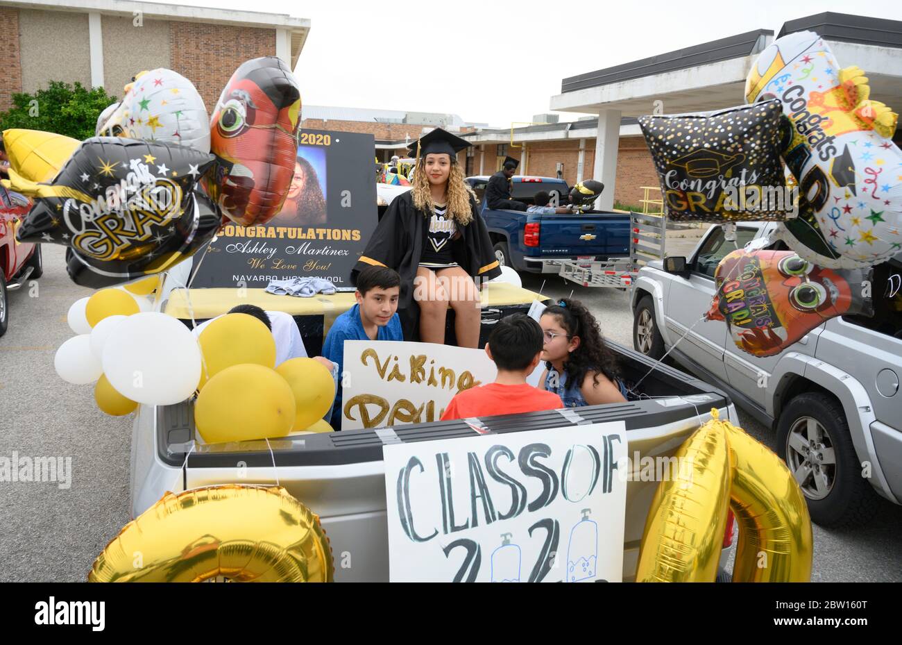 Graduates of Navarro Early College High School, including Ashley Martinez, wait to parade through their north Austin, Texas, neighborhood as they celebrate an academic finale shortened by the coronavirus pandemic. Stock Photo