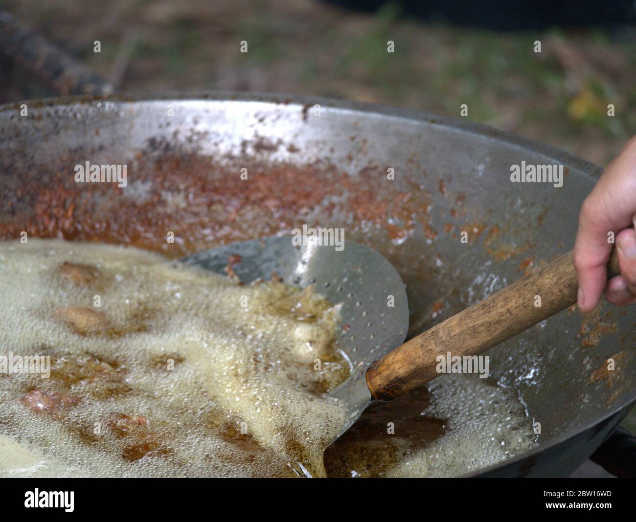 Chicken meat is being deep fried in wok Stock Photo Alamy