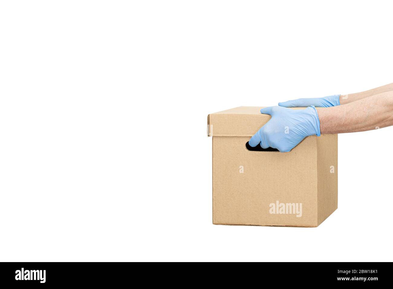 Delivery man holding cardboard boxes in rubber gloves isolated over white, copy space. Fast and free Delivery transport. Online shopping and Express d Stock Photo