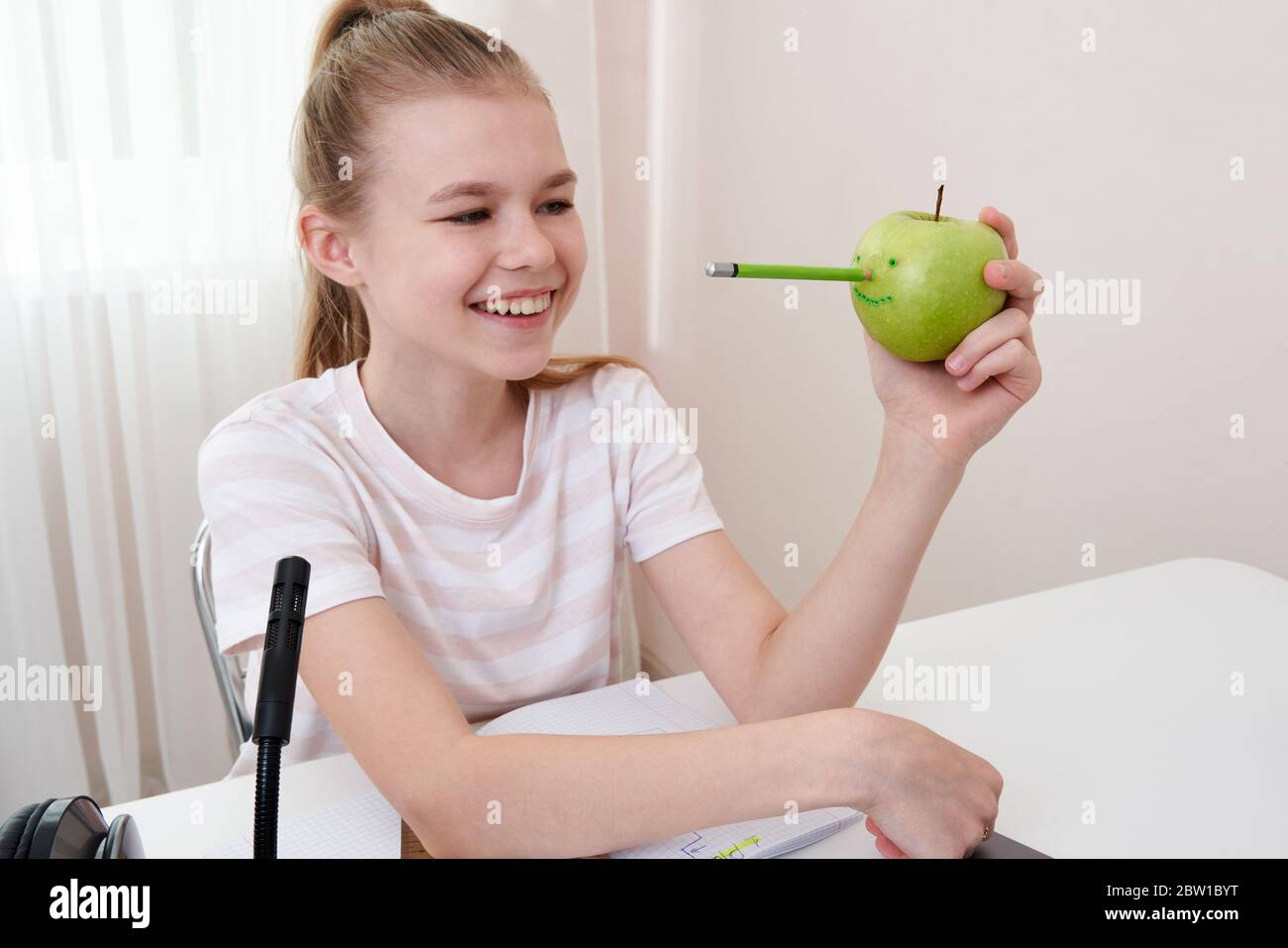 Girl Having Fun With Green Apple While Doing Homework Joy Concept 