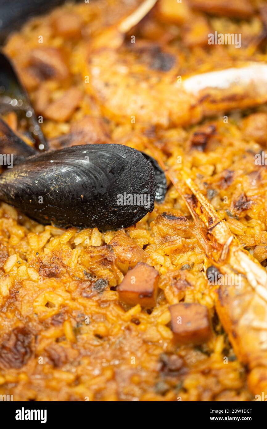 Spanish paella rice with seafood served on a pan close up still Stock