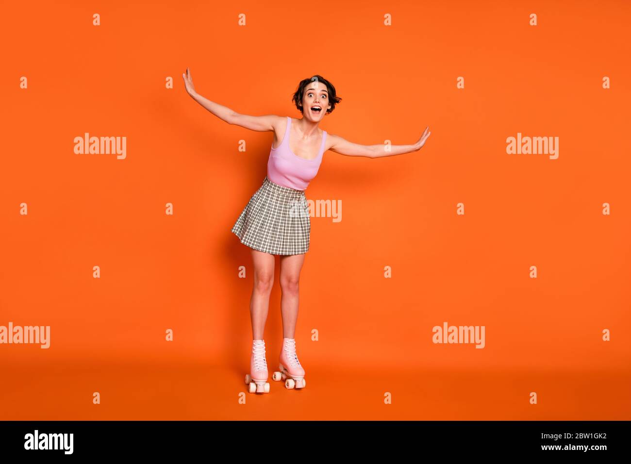 Look i can fly. Full length photo of energetic surprised girl ride