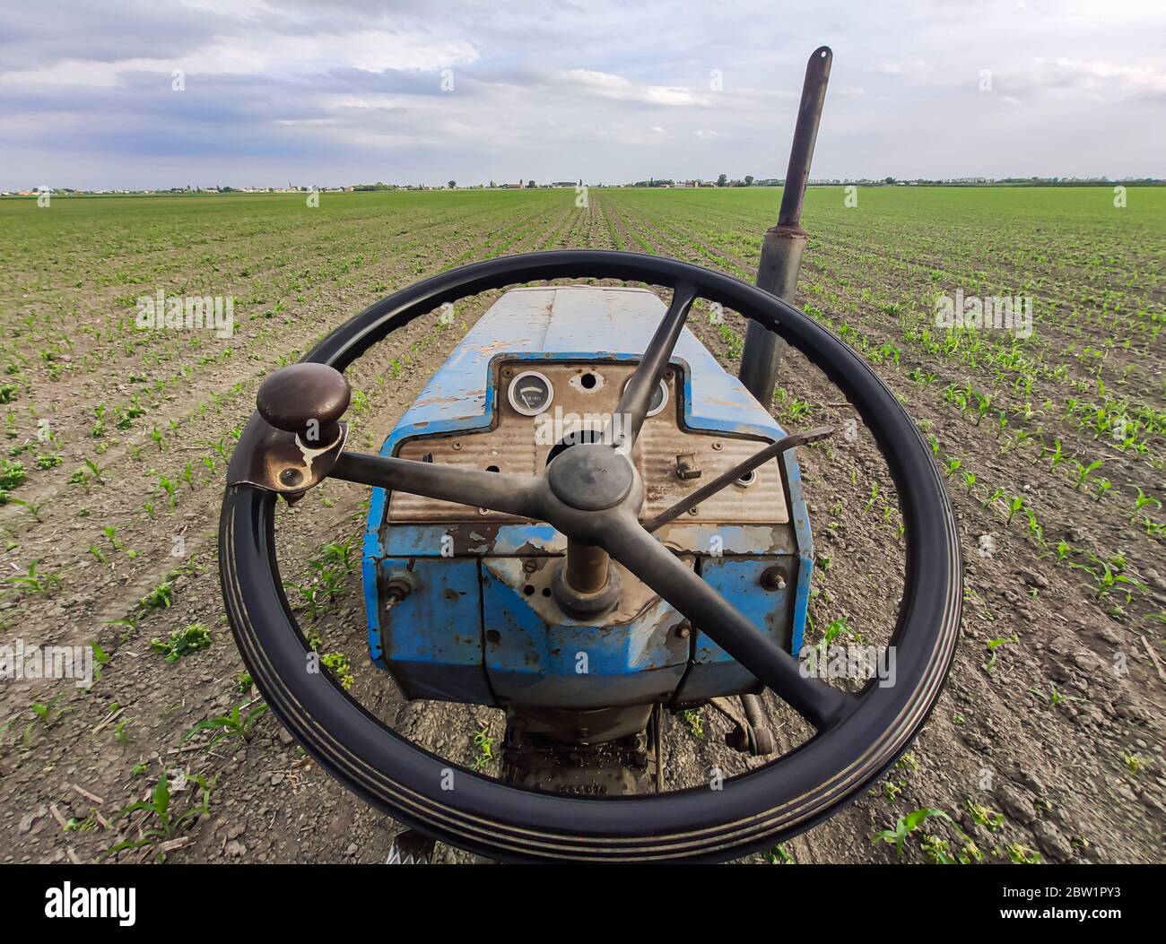 Old rusty tractor in fields 2 Stock Photo - Alamy
