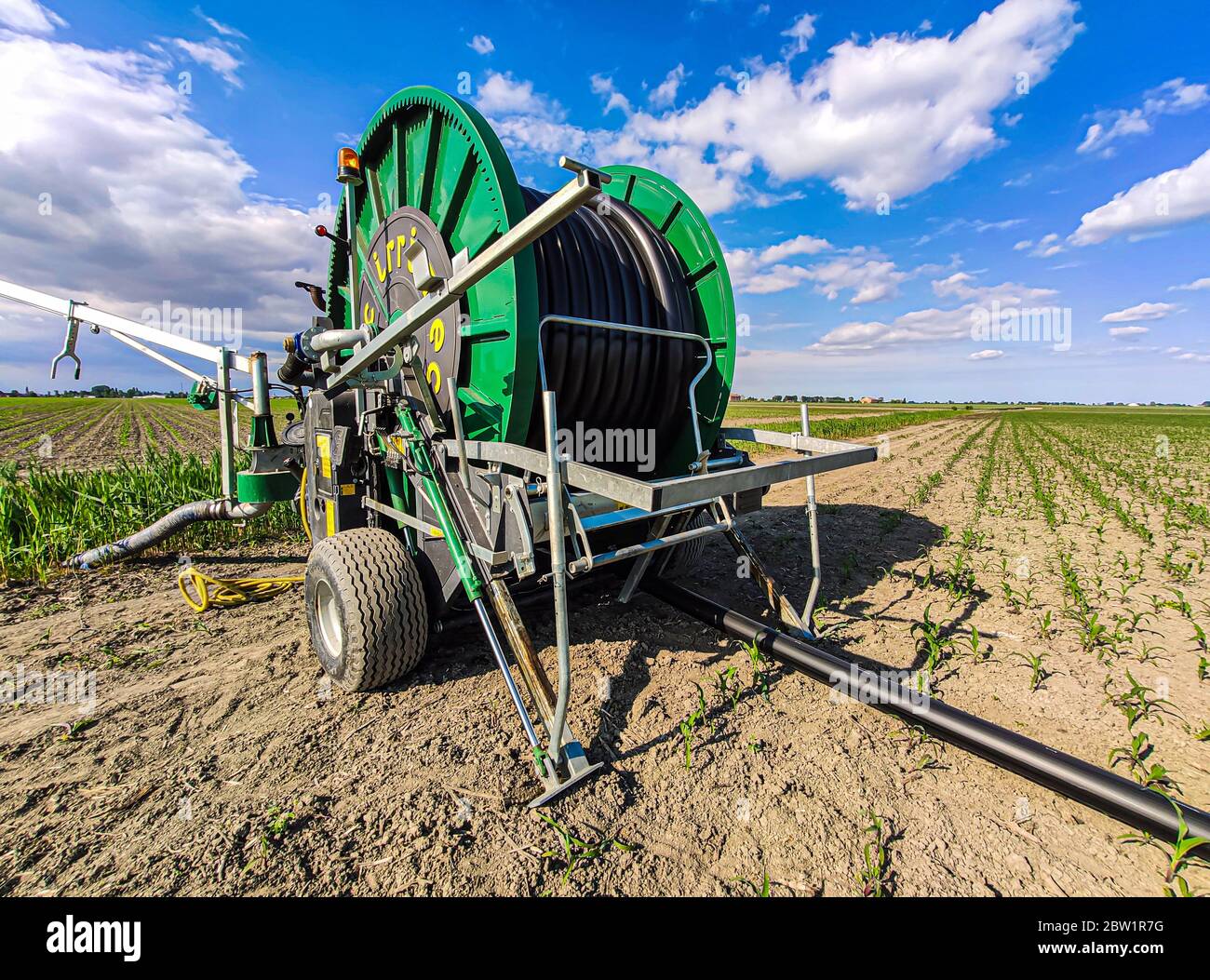 Hose reel sprinkler in fields Stock Photo Alamy
