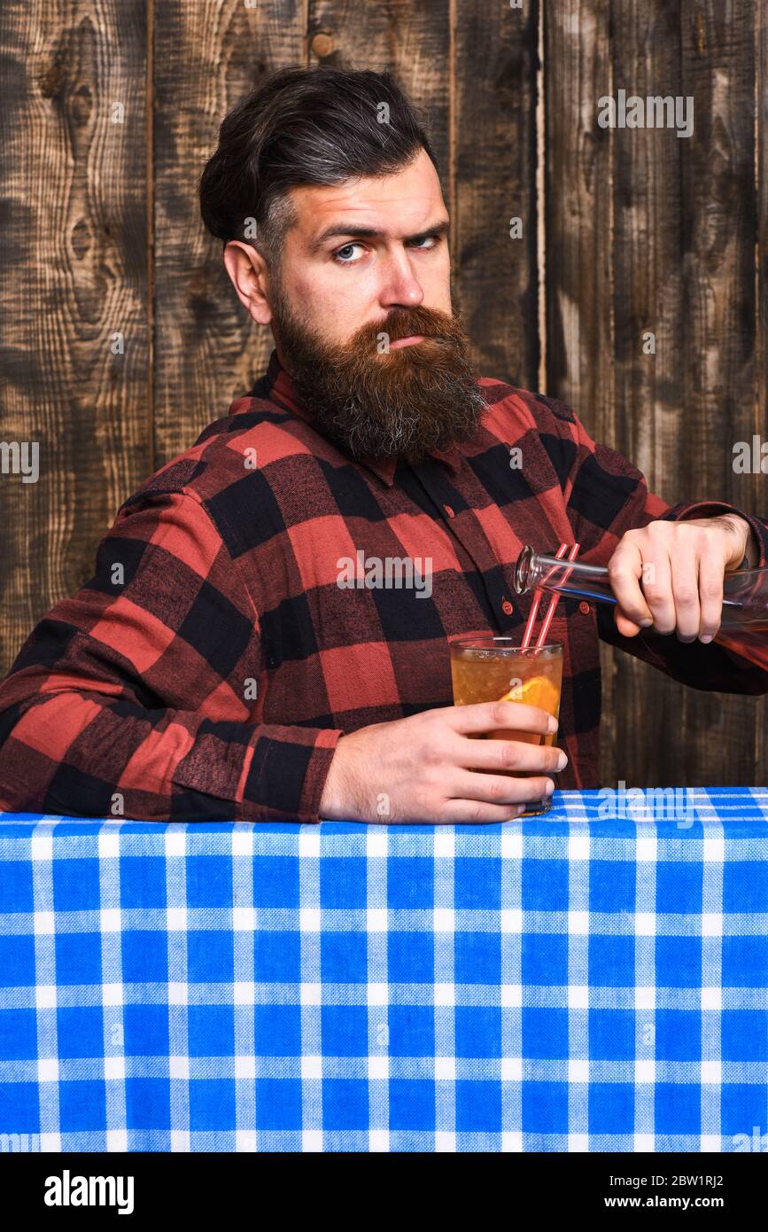 https://c8.alamy.com/comp/2BW1RJ2/bartender-concept-bartender-pouring-glass-barman-with-beard-and-strict-face-holds-cocktail-glass-and-bottle-with-alcohol-in-hands-man-in-checkered-shirt-on-wooden-background-blue-tablecloth-2BW1RJ2.jpg