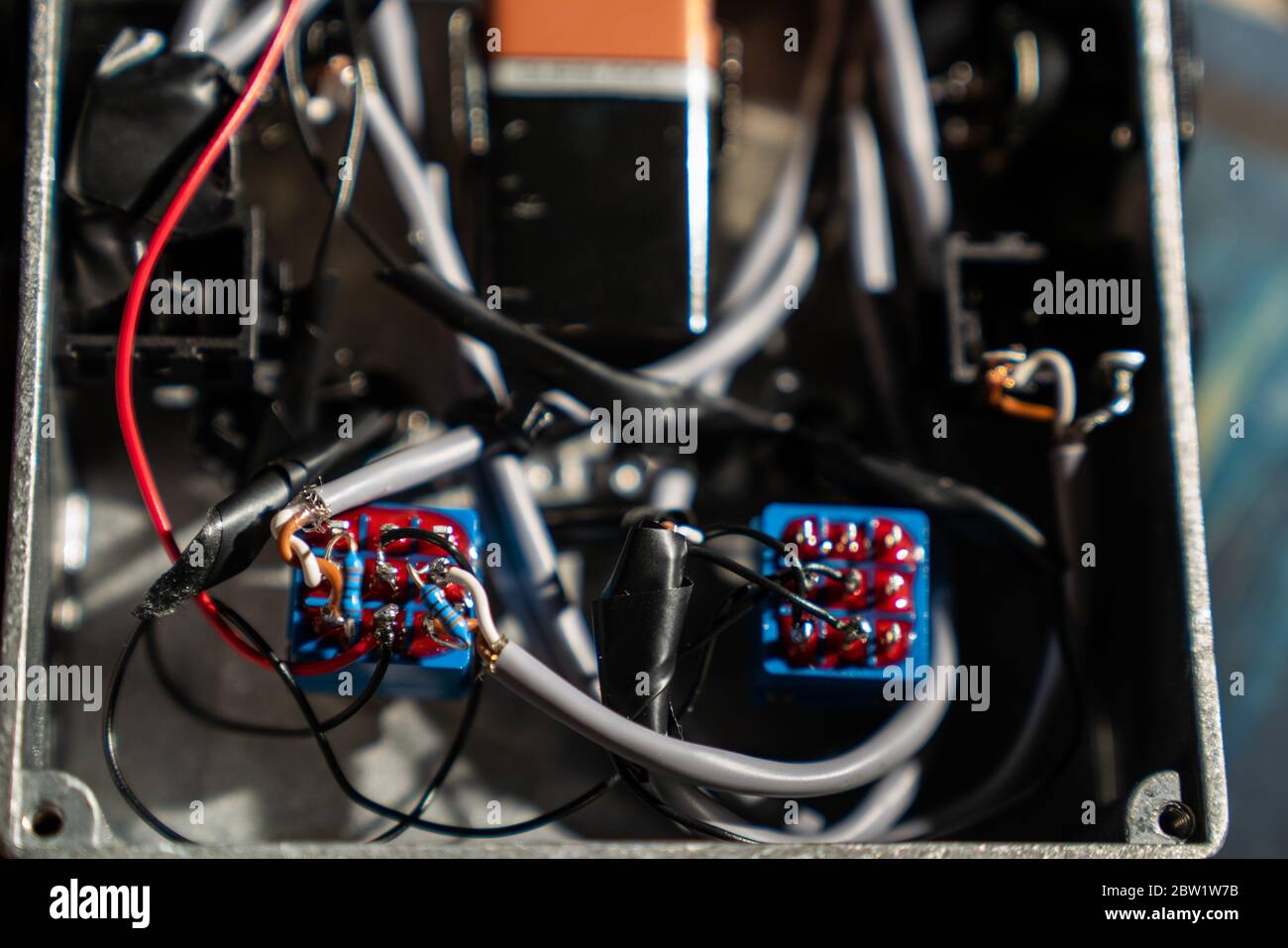 The cables and components making up a home made switching unit for audio devices. Enclosed in a rugged steel box. Stock Photo