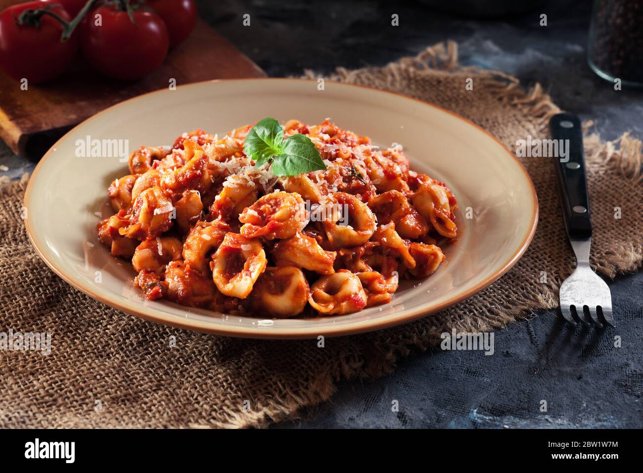 Fresh tortellini with homemade tomato sauce and parmesan cheese. Italian cuisine Stock Photo