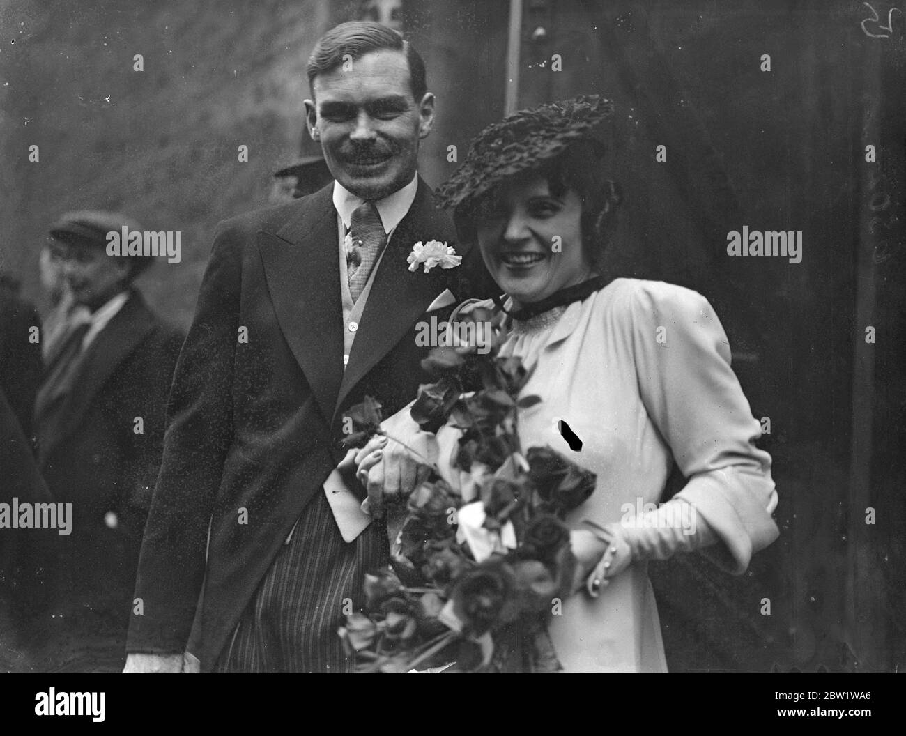 Film actress weds sheep farmer in London. Miss Claire Adams, a film actress of the silent picture days, was married at Christchurch, Down Street, to Mr Donald John Scobie Mackinnon, 32-year-old owner of a sheep farm at Mooramong, Western Victoria. The couple fell in love when they met at a cocktail party in the West End a few weeks ago. The bride, who played the lead in the several American pictures, was the widow of Mr Benjamin B. Hampton, a film producer. Photo shows: the bride and groom after the ceremony. 1 April 1937 Stock Photo
