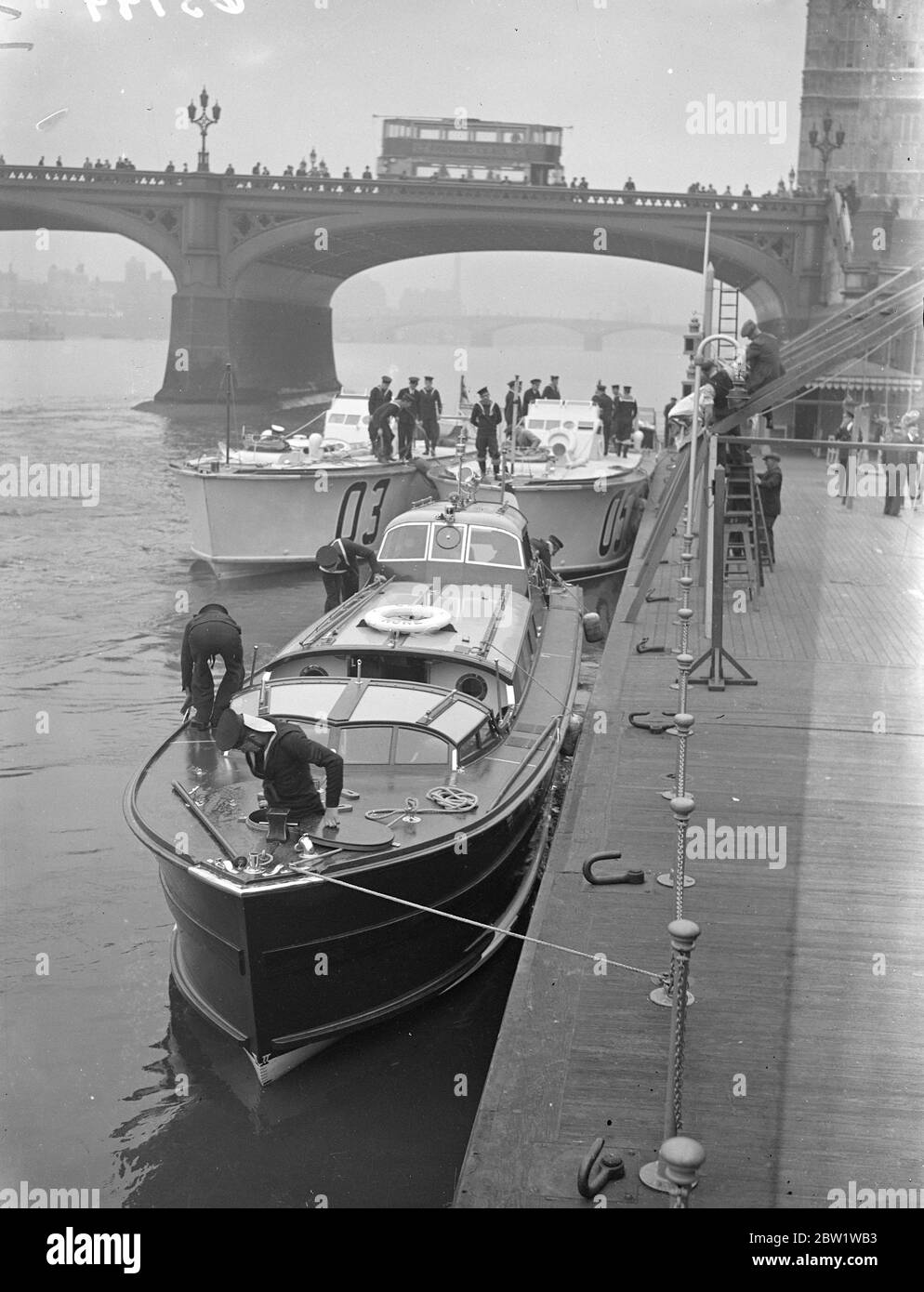 King is barge moored in Pool of London. The Astros barged (extreme right), in which the King and Queen will go to Greenwich for the opening of the National Maritime Museum next Tuesday, moored with the accompanying motor torpedo boats alongside the destroyer's 'HMS Wishart (D67)' in the Pool of London. The 'Wishart', watch was to act as escort but was damaged when mooring in the Pool. 24 April 1937 Stock Photo